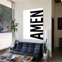 AMEN white acrylic wall art — black sofa