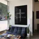 Do Not Fear Cross acrylic wall art above a black sofa