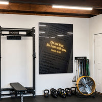 Do Not Fear acrylic wall art displayed in a home gym