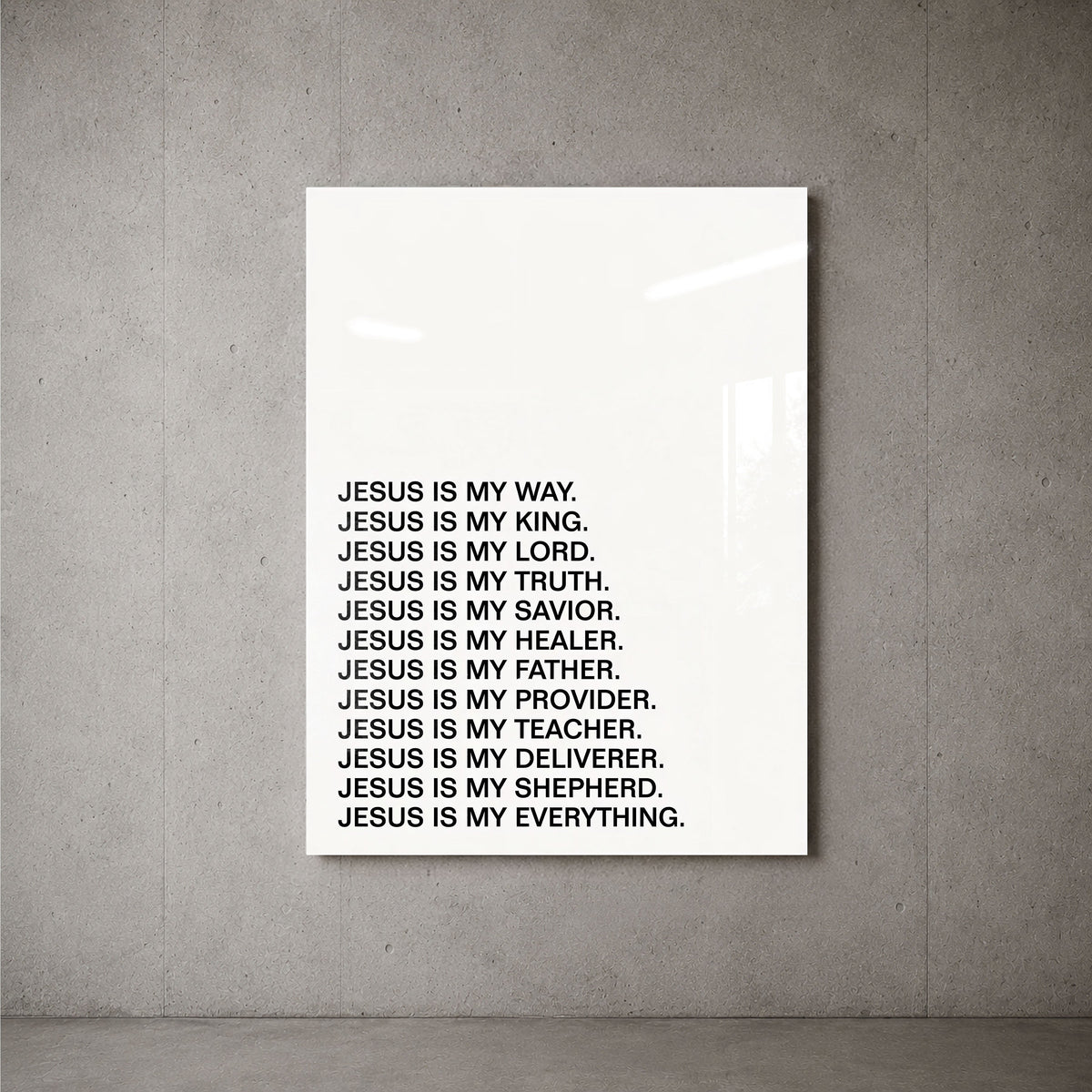 Jesus Is minimalist acrylic wall art on a concrete wall