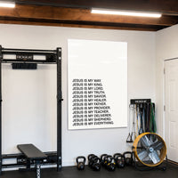 Jesus Is acrylic wall art displayed in a home gym