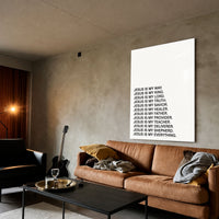 Jesus Is acrylic wall art displayed above a brown sofa
