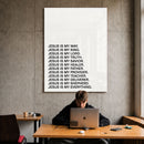 Jesus Is acrylic wall art displayed above a workspace