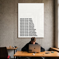 Jesus Is acrylic wall art displayed above a workspace