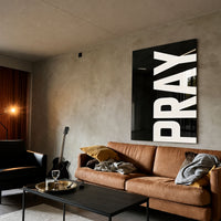 Pray black acrylic wall art — brown sofa