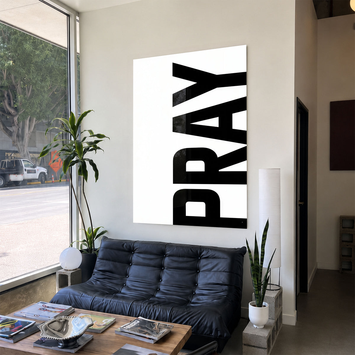 Pray white acrylic wall art — black sofa