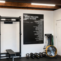 What You Can Give To God acrylic wall art displayed in a home gym